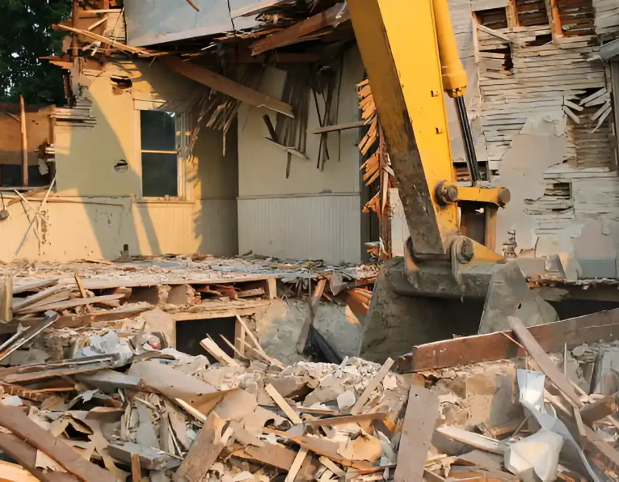 Excavator Demolishing Residential Structure