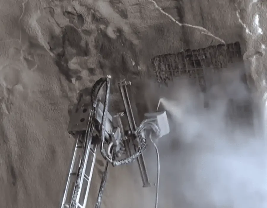 Robotic demolition equipment performing precise concrete removal with dust suppression system