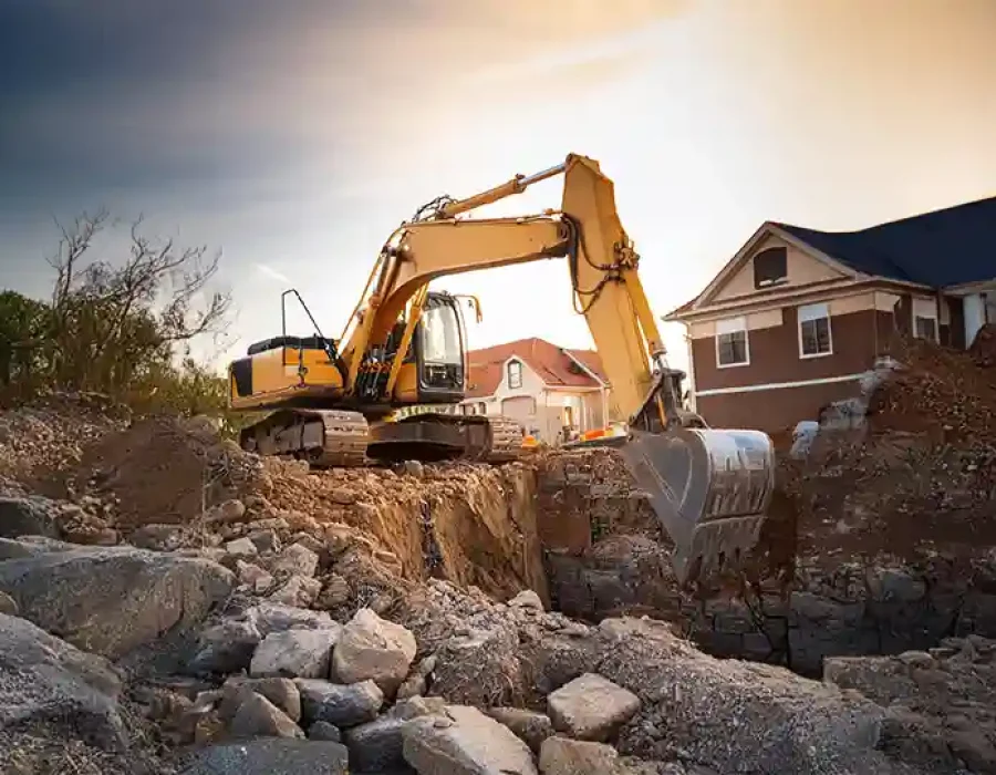 Excavator digging at a residential site for foundation preparation.