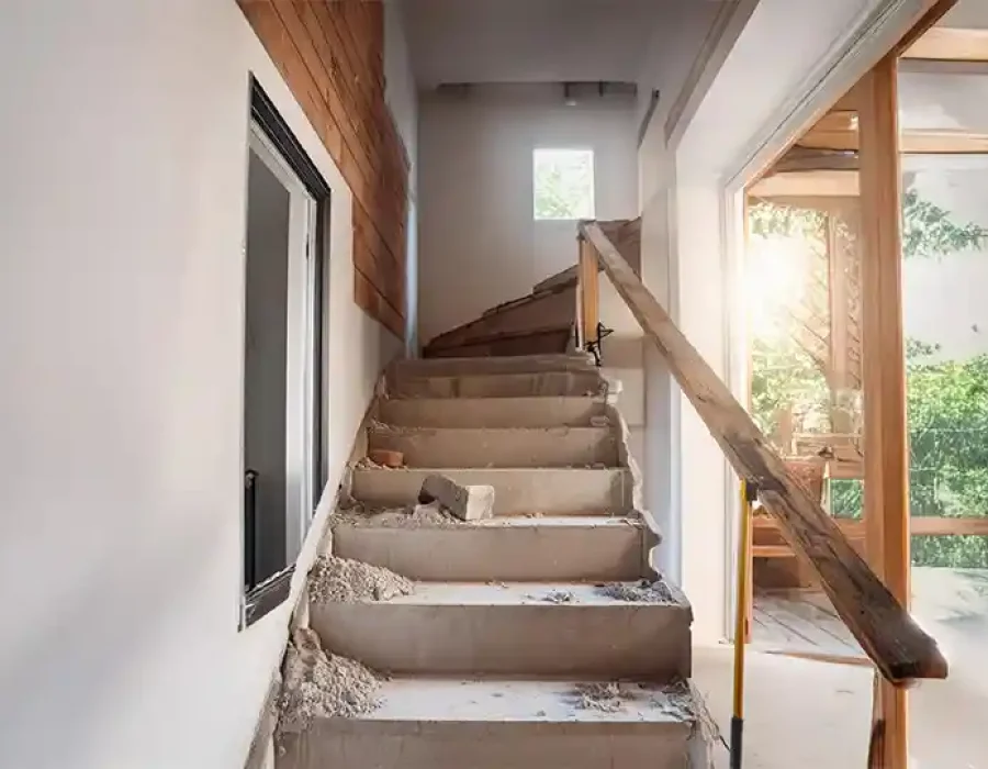 Partially demolished staircase with debris removal