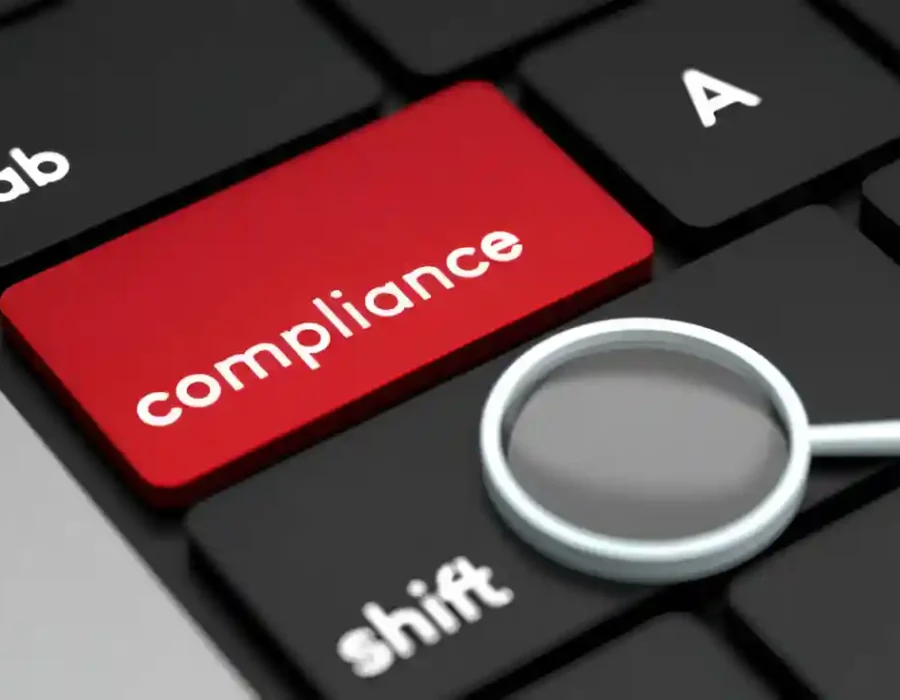 Red compliance key on keyboard with magnifying glass - demolition safety standards and regulatory inspection