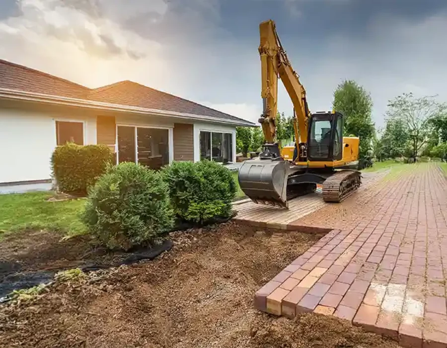 Heavy equipment performing demolition and debris removal at a construction site.