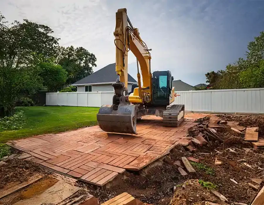 Heavy machinery clearing debris during demolition and site preparation work.