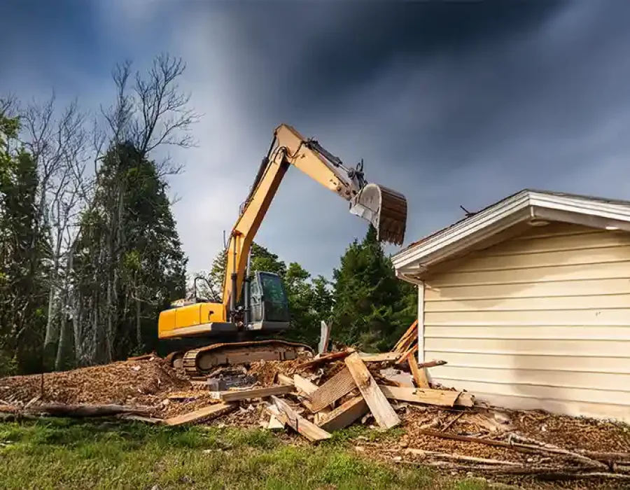 Heavy machinery and crew clearing demolition debris for efficient site preparation and cleanup.