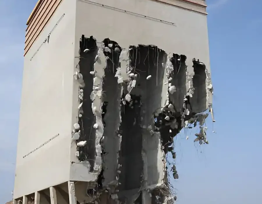 Industrial building with strategic concrete wall removal, professional demolition site cleanup