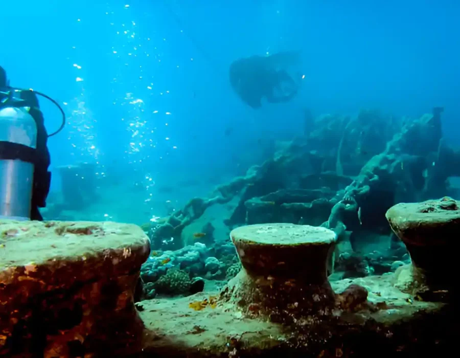 Diver assesses sunken concrete structures for marine demolition project